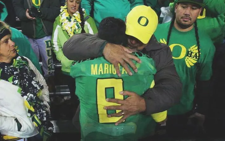 Toa hugging his son Marcus