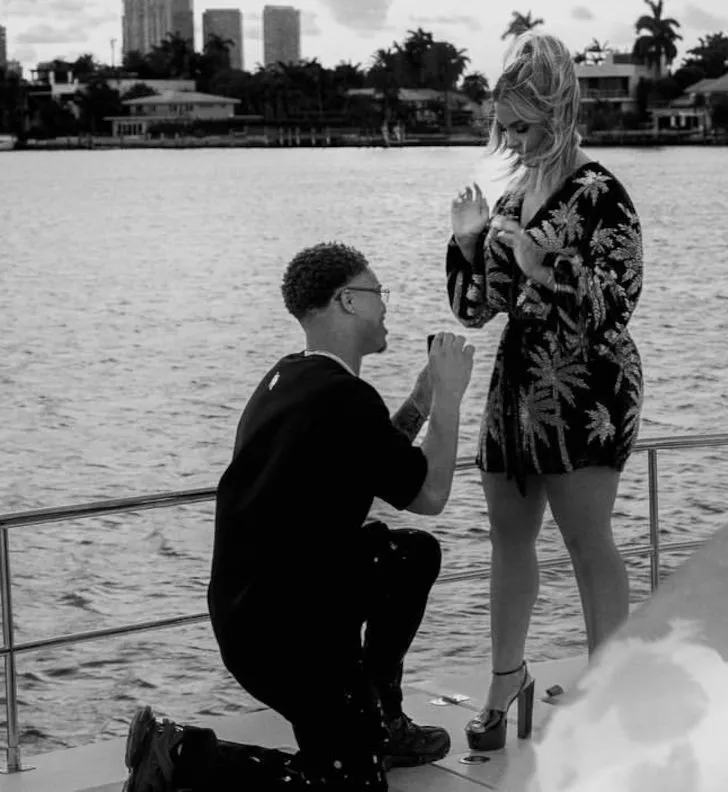 A photo showing Taron Johnson proposing to his then-girlfriend Meghan