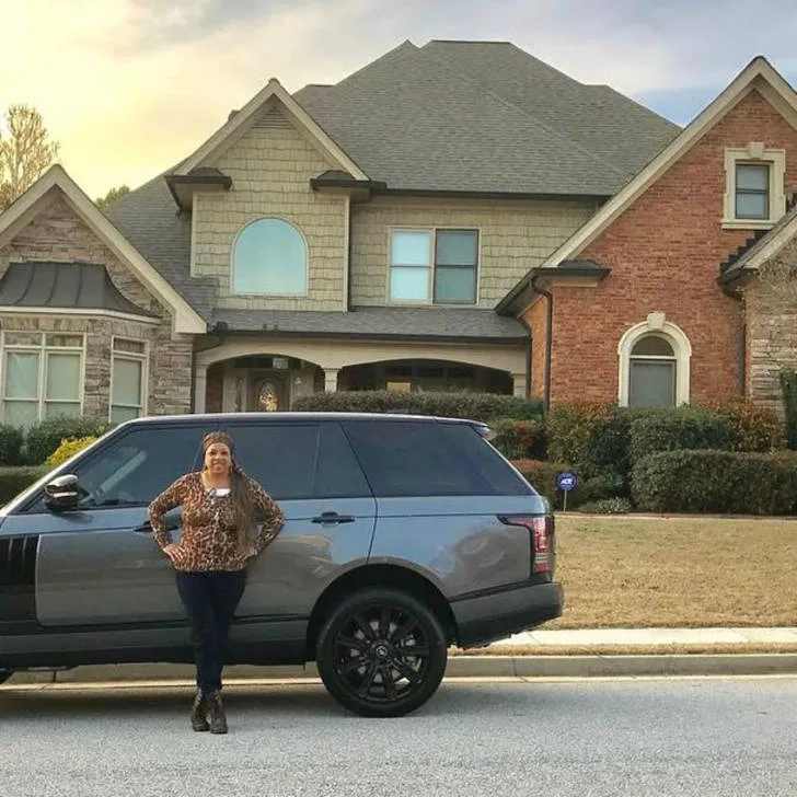 Michelle Green in front of her new car and house.